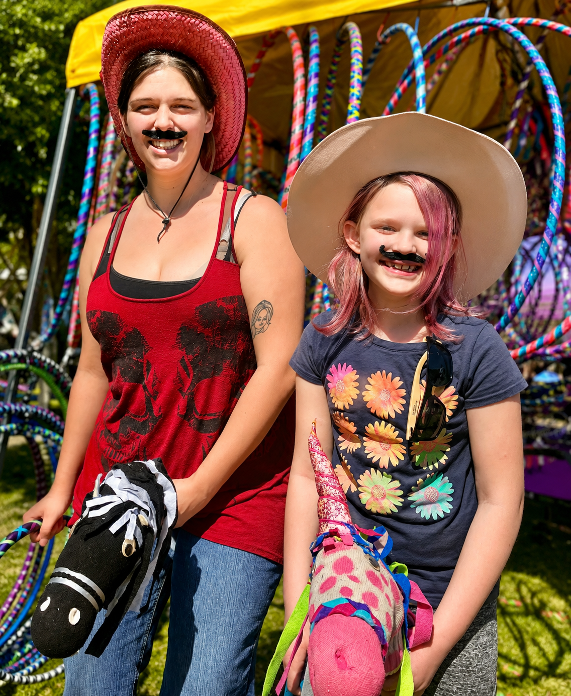 Girls racing on stick ponies at a Sunshine Hoops rodeo themed party